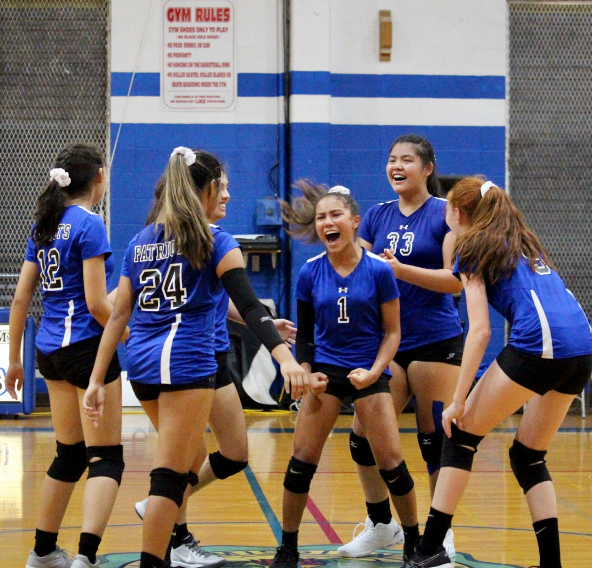 Christian Academy Patriots volleyball players celebrating in the school gym